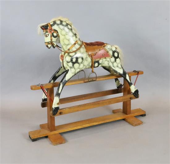 A Collinson carved and painted wood rocking horse, original paint and original cow mane and tail,